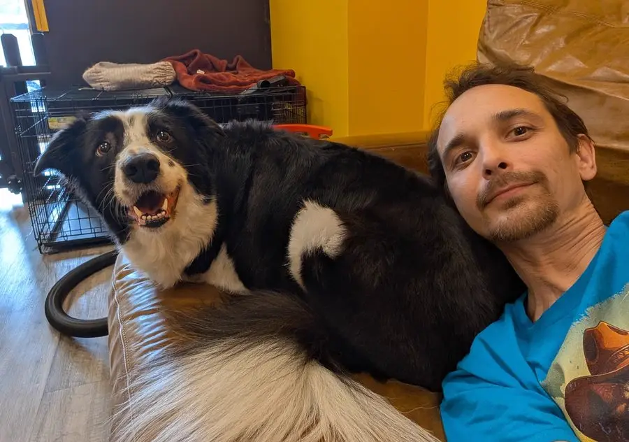Gary relaxing with a dog at Sweet Beans Grooming