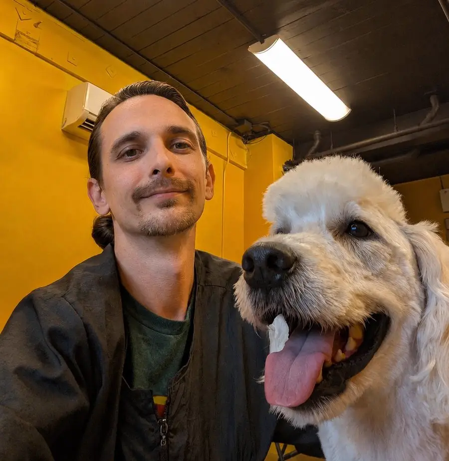 Gary with a freshly groomed golden retriever at Sweet Beans Grooming